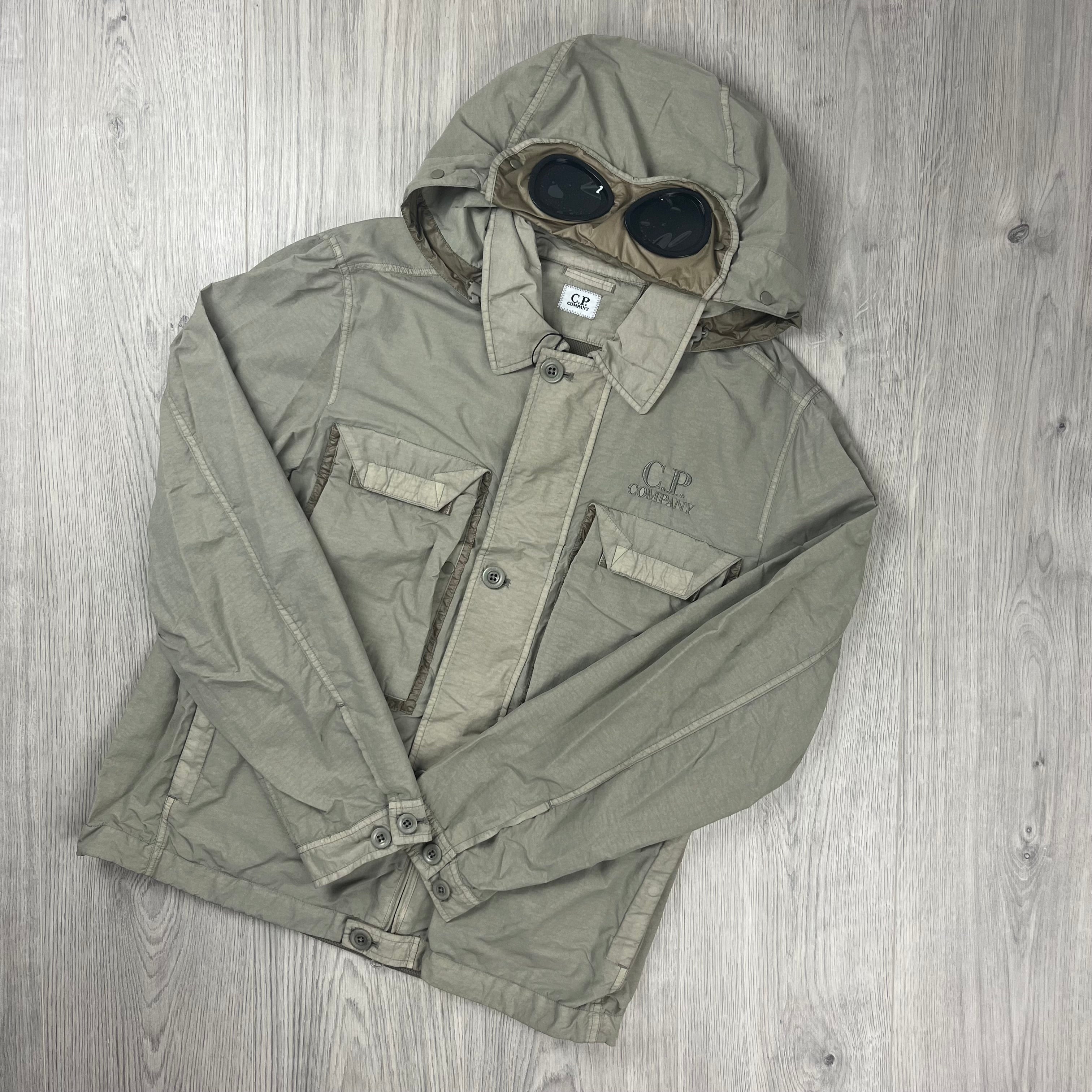 CP Company Flatt Nylon Hooded Overshirt in Vintage Khaki. On sale at Open Attire.