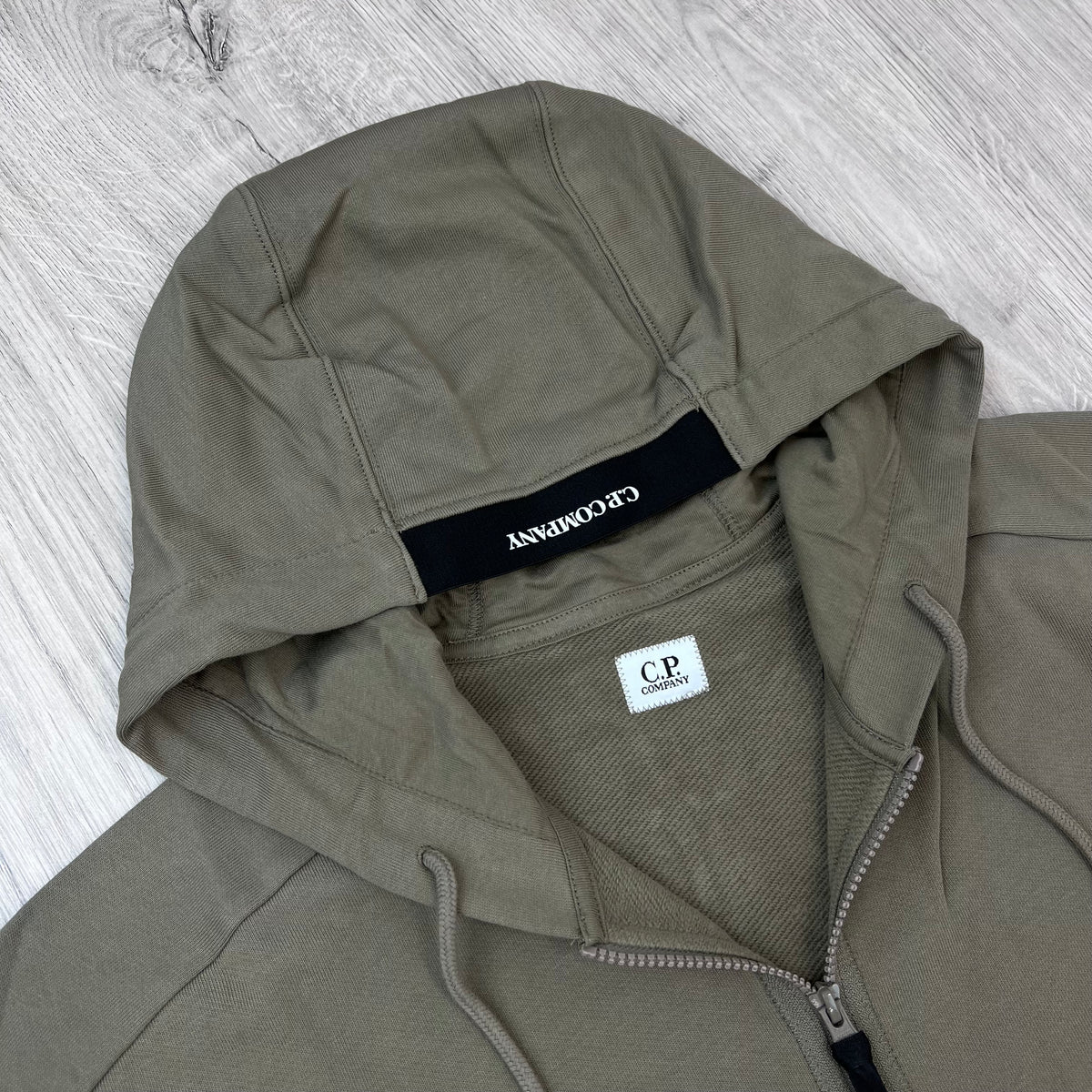 A close up view of the hood on a CP Company Raised Fleece Zip Hoodie in Fallen Rock.