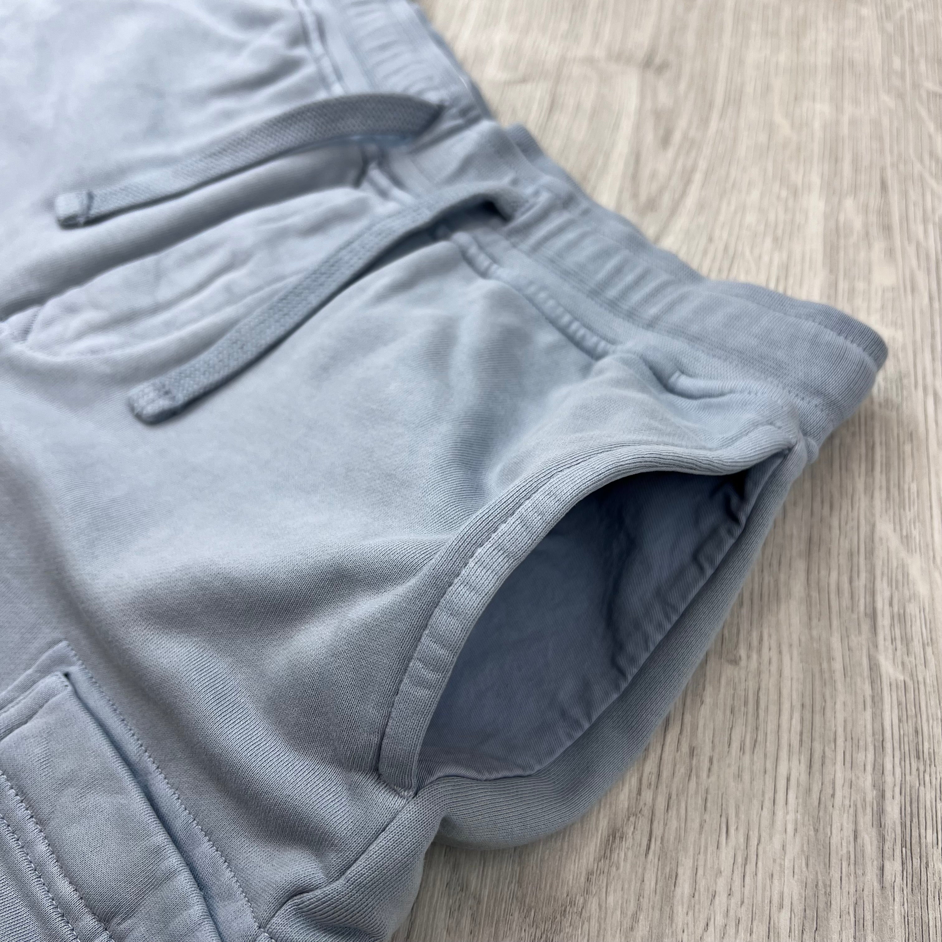 A close up view of the hand pockets on the Stone Island Jersey Shorts in Ash Grey. 
