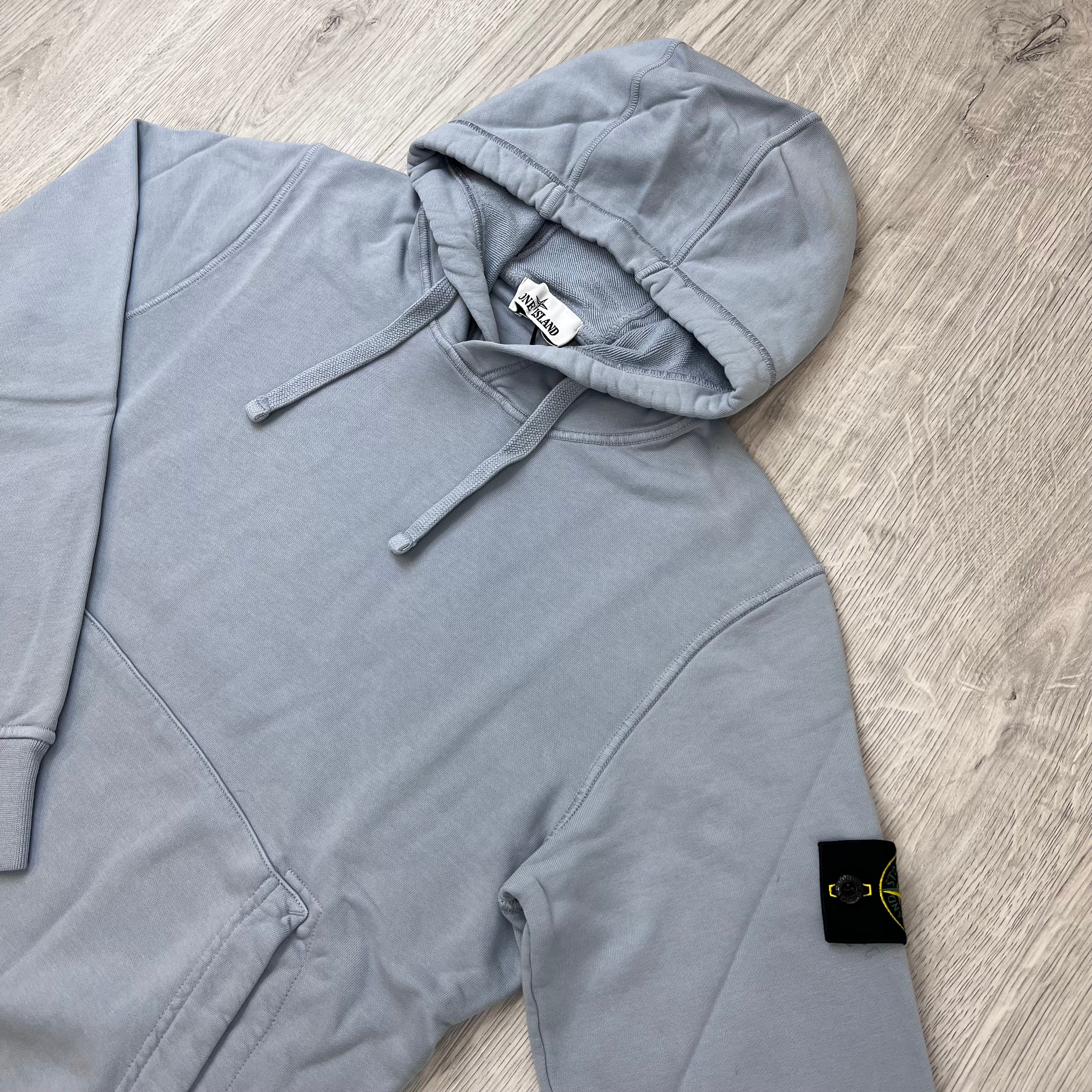 Angled view of a Stone Island Pullover Hoodie in Ash Grey. 