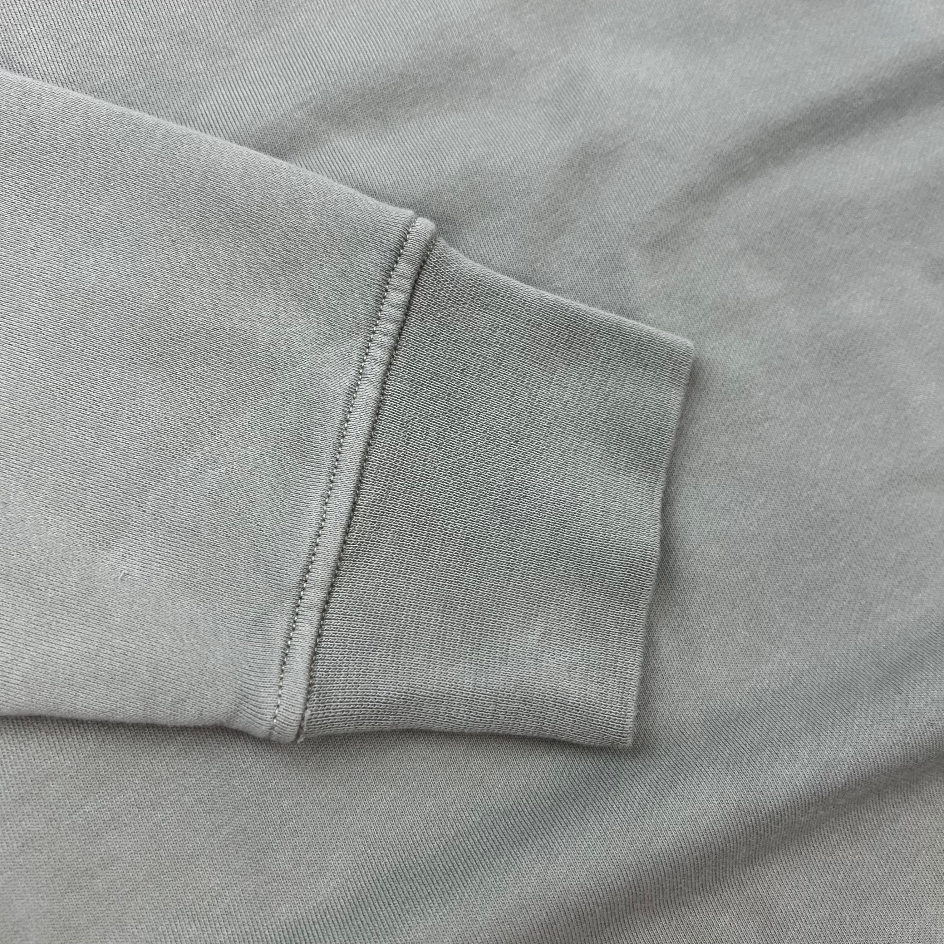 A close up view of the cuffs on a Stone Island Crewneck Sweatshirt in Laurel Green.