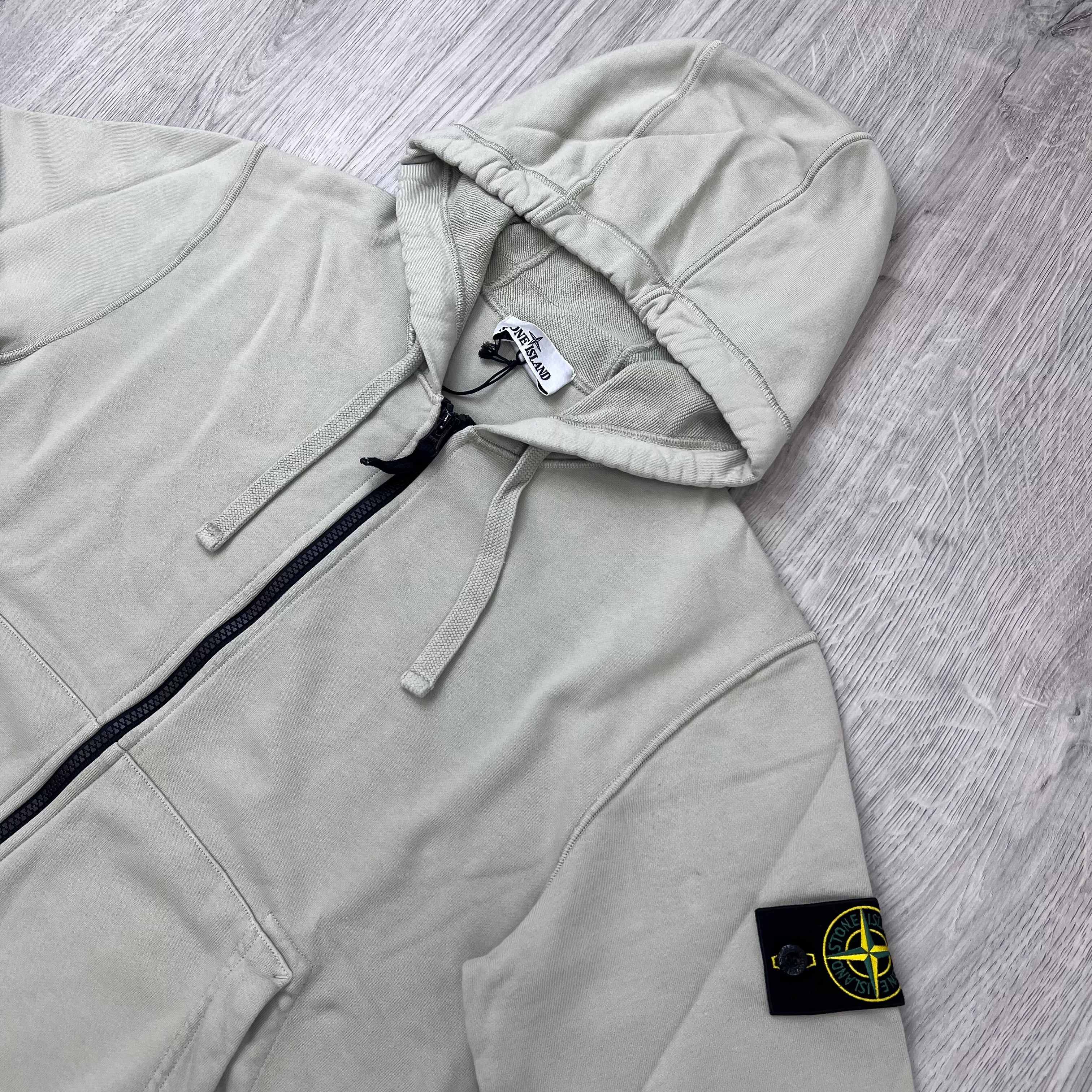 Angled view of the Stone Island Zip Hoodie in Sand. 